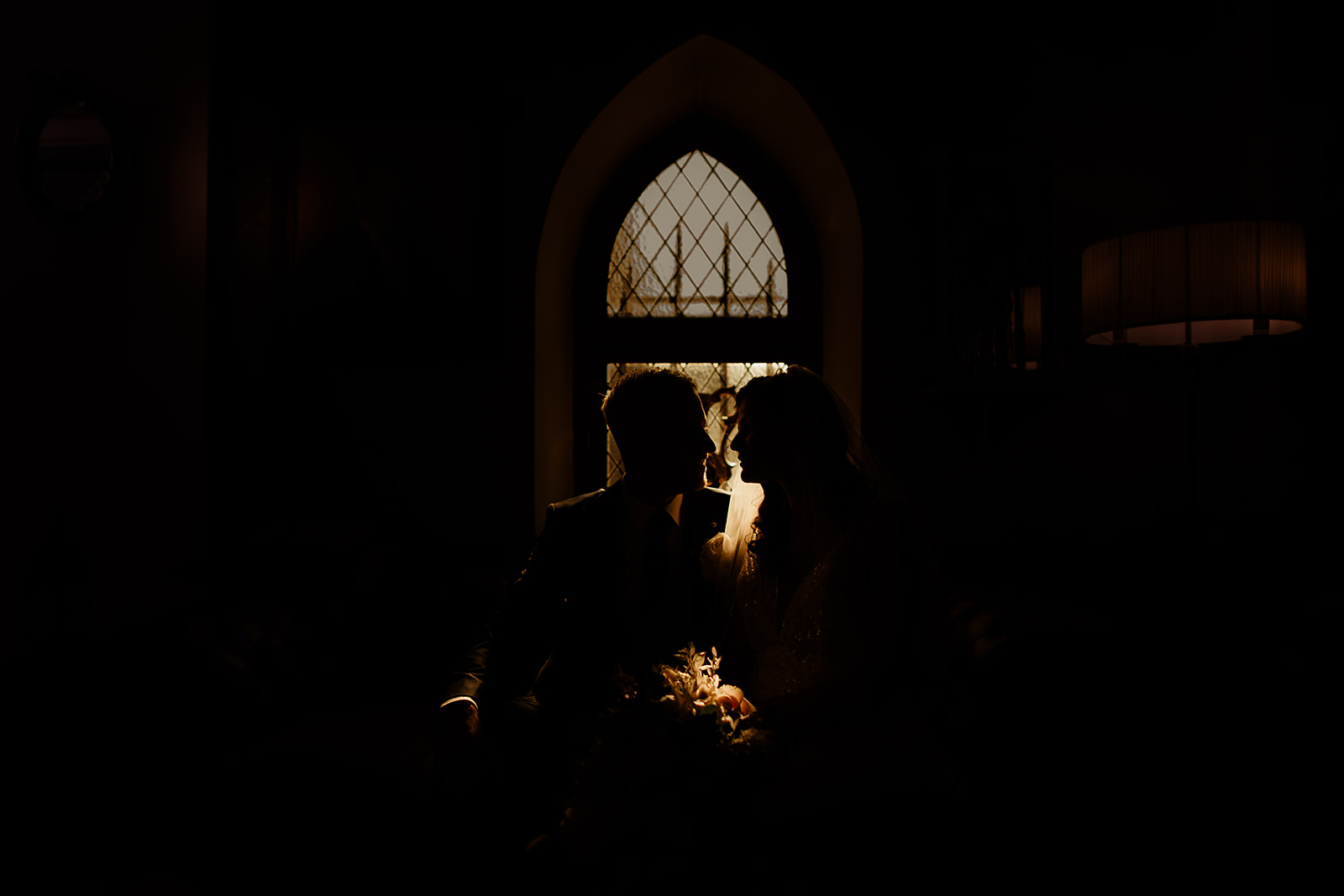 Shauna and Keith silhouetted against a castle window