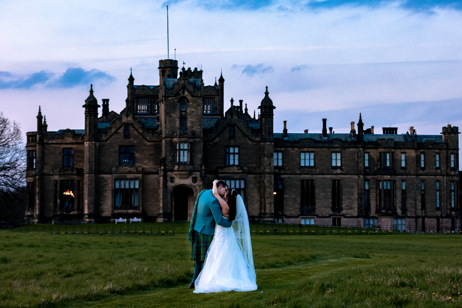 Zoe and Paul together in front of Allerton Castle at dusk