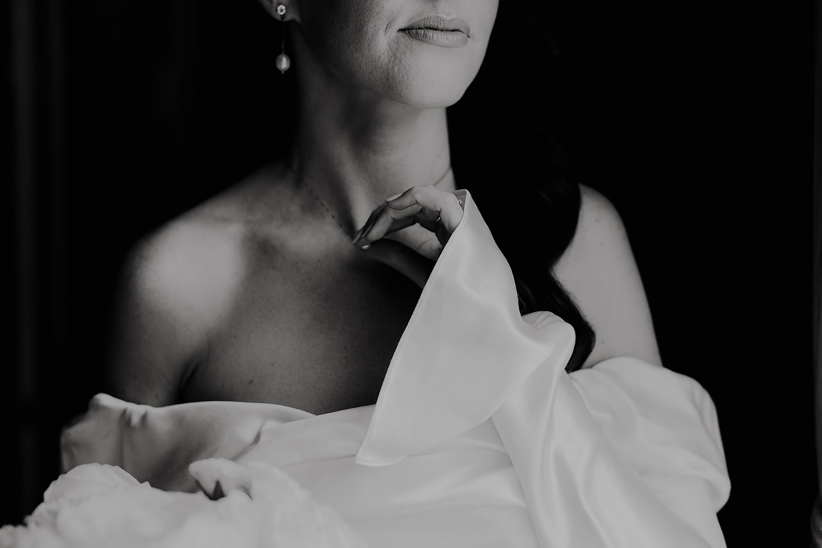 Black and white bridal portrait of Laoise, showing the detail of her off-the-shoulder wedding dress