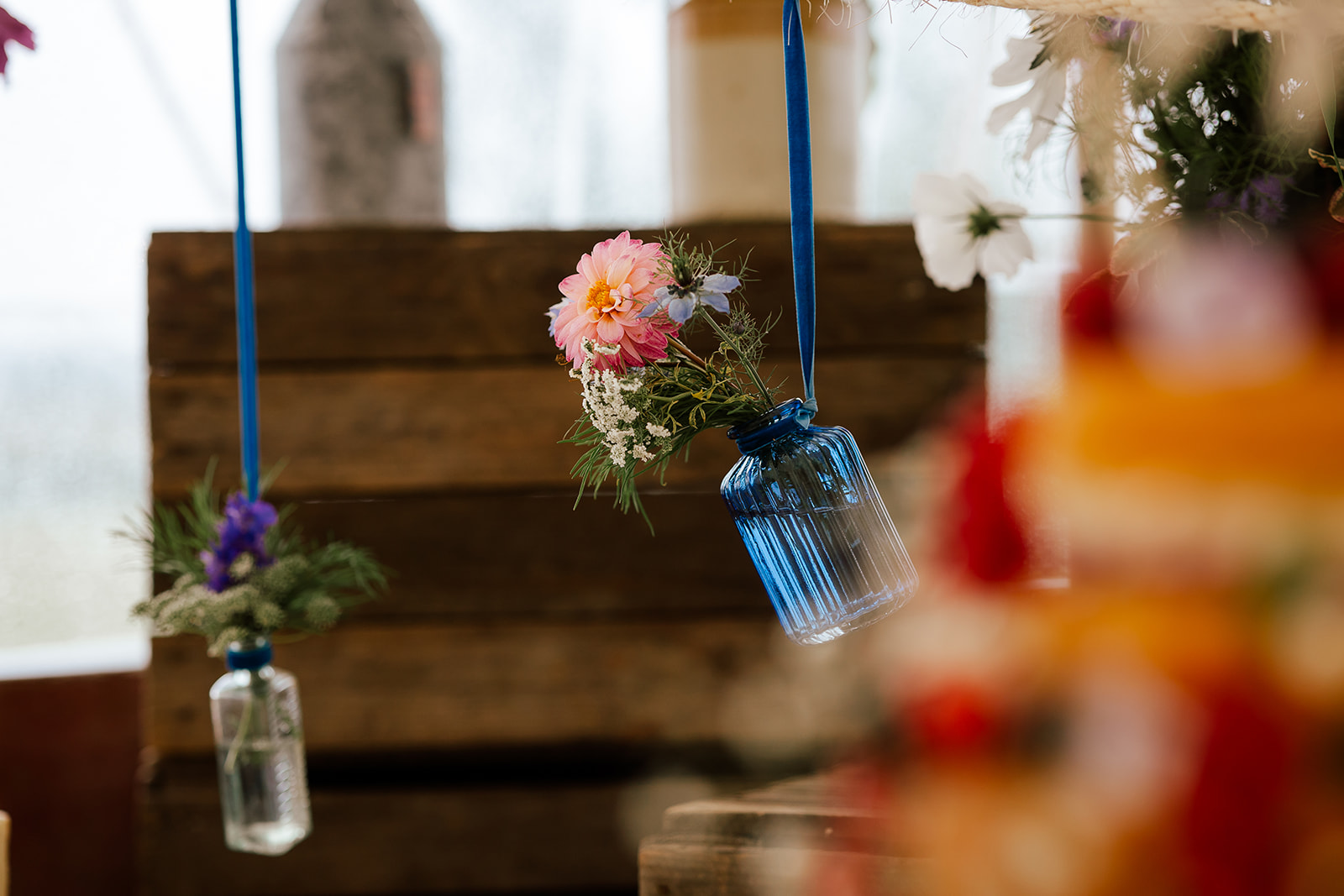 DIY wedding reception in marquee with jars of wildflowers
