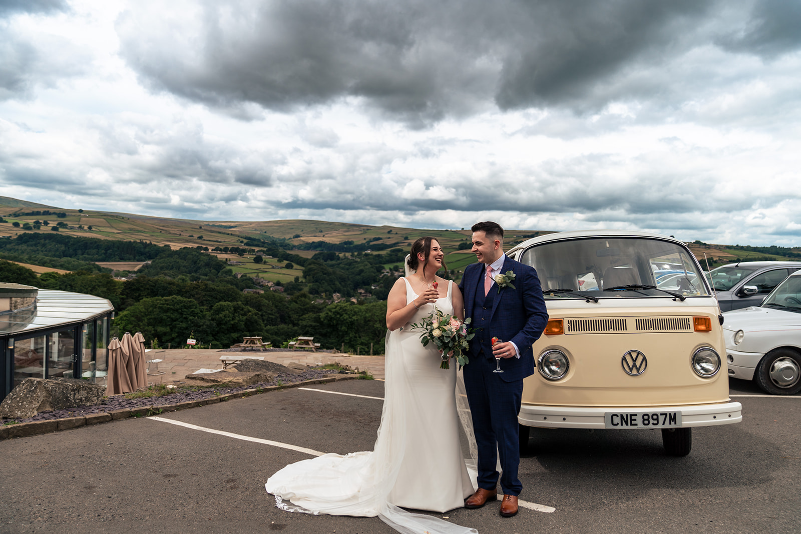Chloe and Jordan together beside their wedding campervan