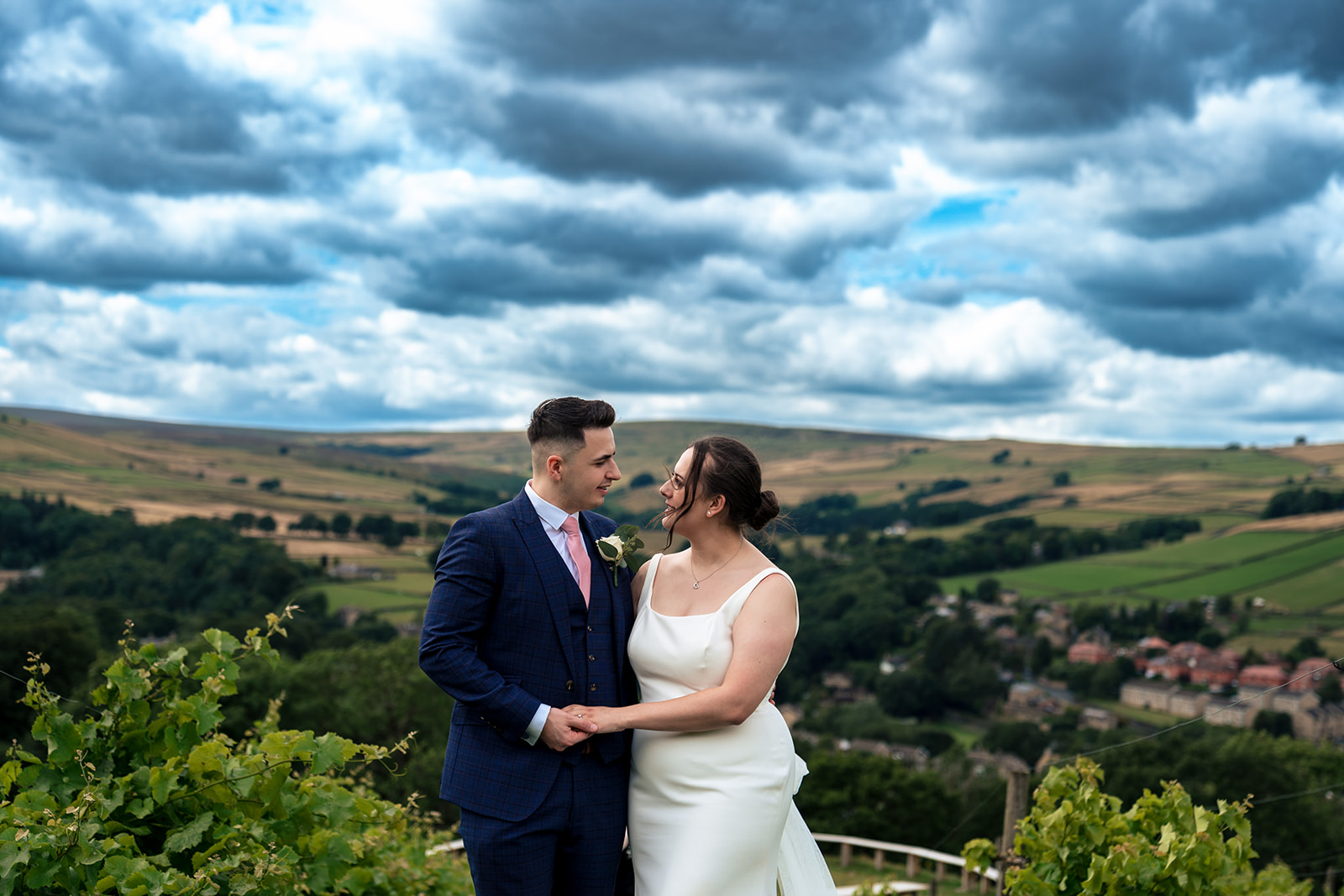 Chloe and Jordan smiling together among the vines at Holmfirth Vineyard
