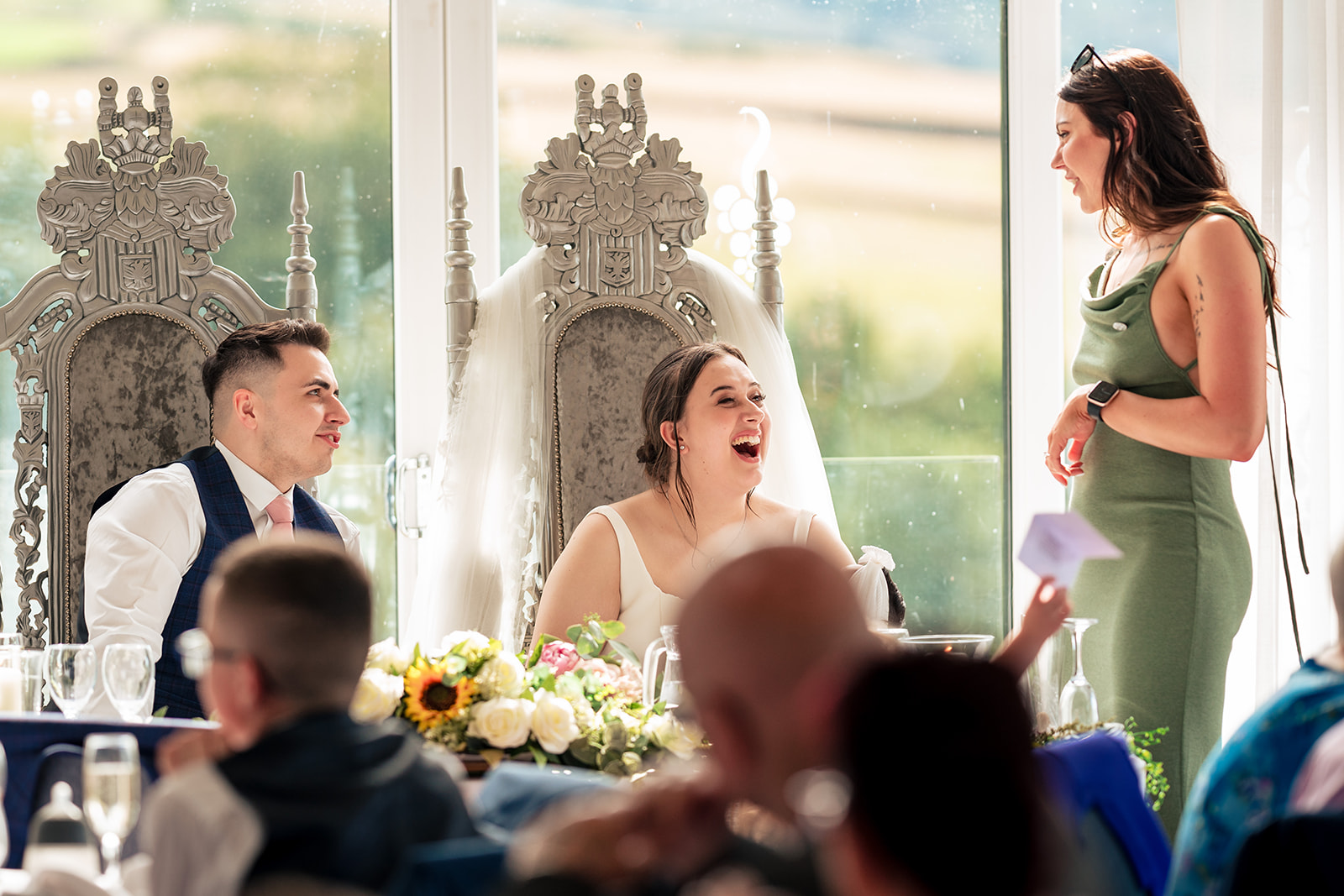 Chloe and Jordan laughing together during the wedding speeches