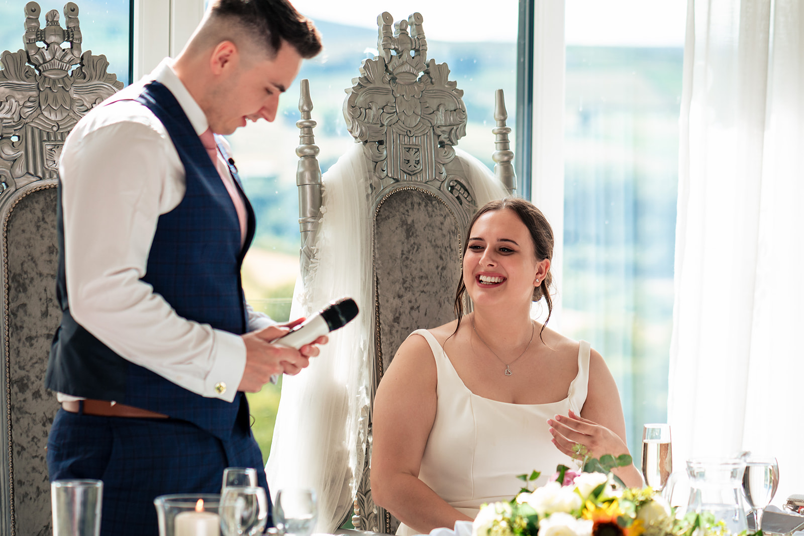 Jordan giving his speech while Chloe smiles beside him