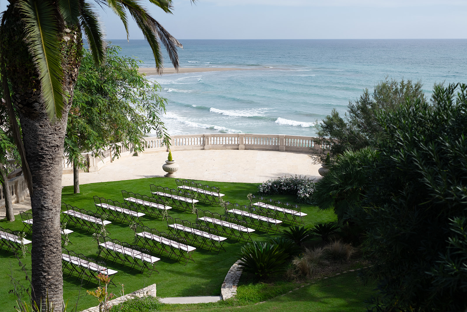 Wedding ceremony set up on the lawn facing the sea at Xalet del Nin, near Sitges