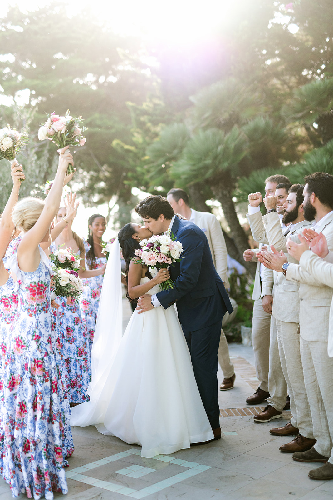 Bride and groom walking back down the aisle under a shower of petals at Xalet del Nin