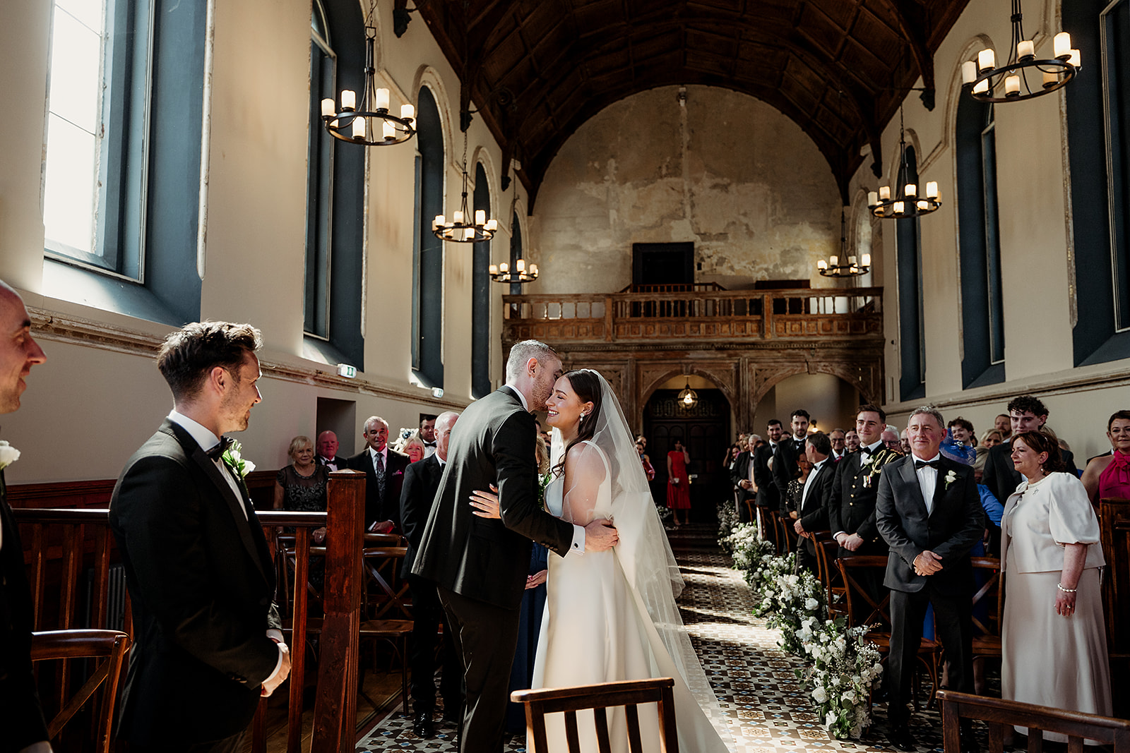 Sorcha arriving at the end of the aisle in The Abbey chapel, surrounded by family and friends