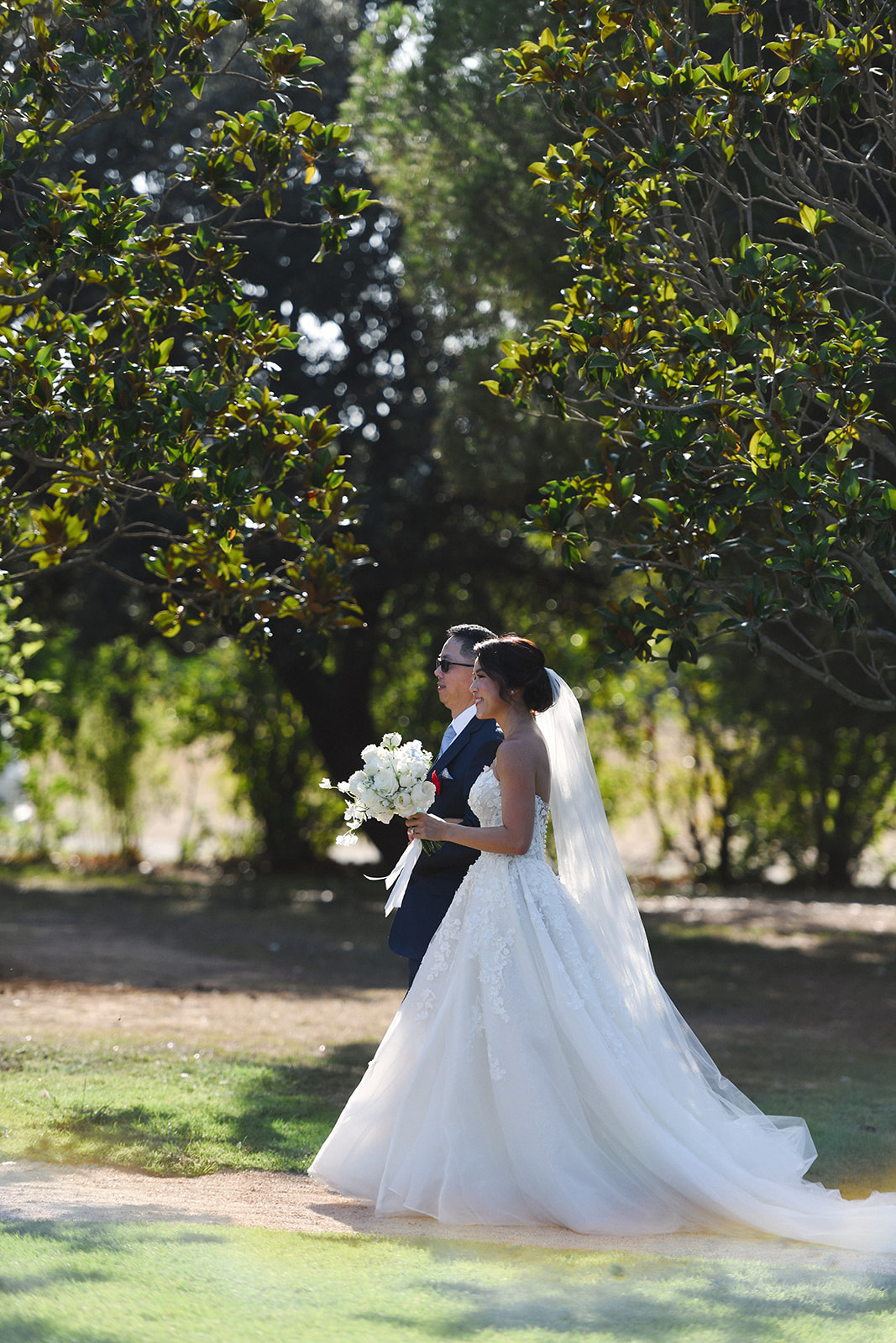 Bride and groom walking through the gardens of Castell de Sant Marçal
