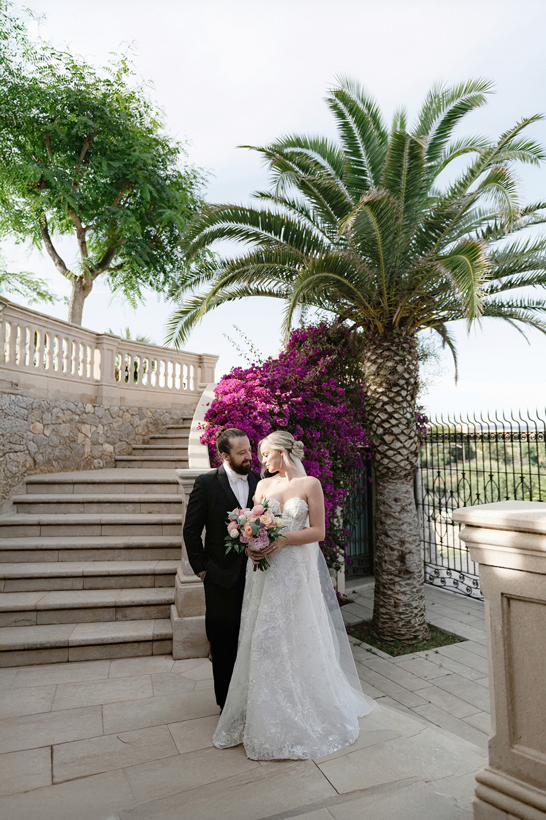 Bride and groom on the garden stairs at Xalet del Nin in soft natural light