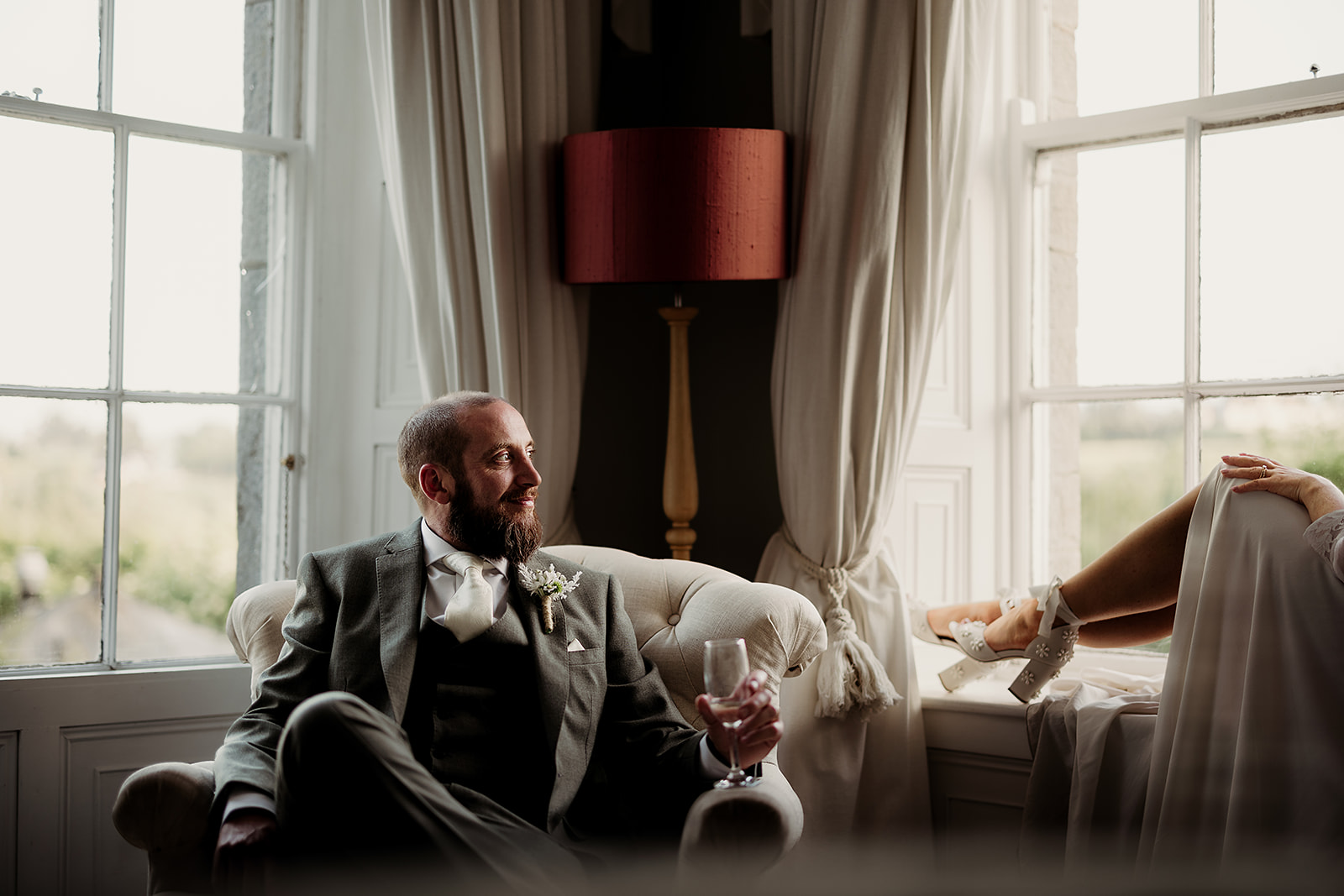A quiet moment by the window during Sarah and Kieran’s wedding