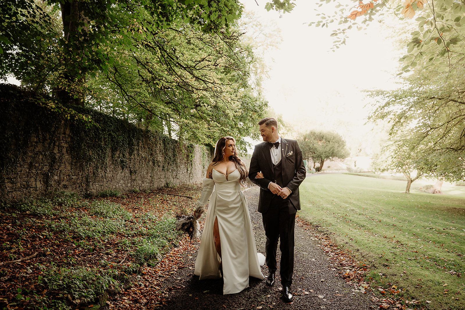 Bella and Shane walk together beside the garden wall at Boyne Hill House.