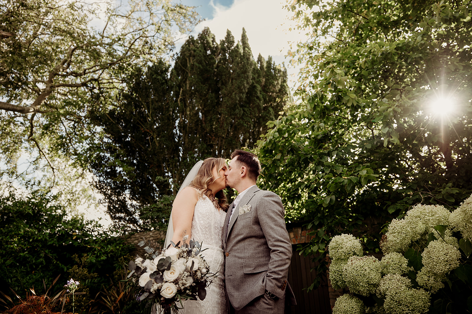 Edel and Oisin kissing in the late afternoon light at Ballymagarvey Village