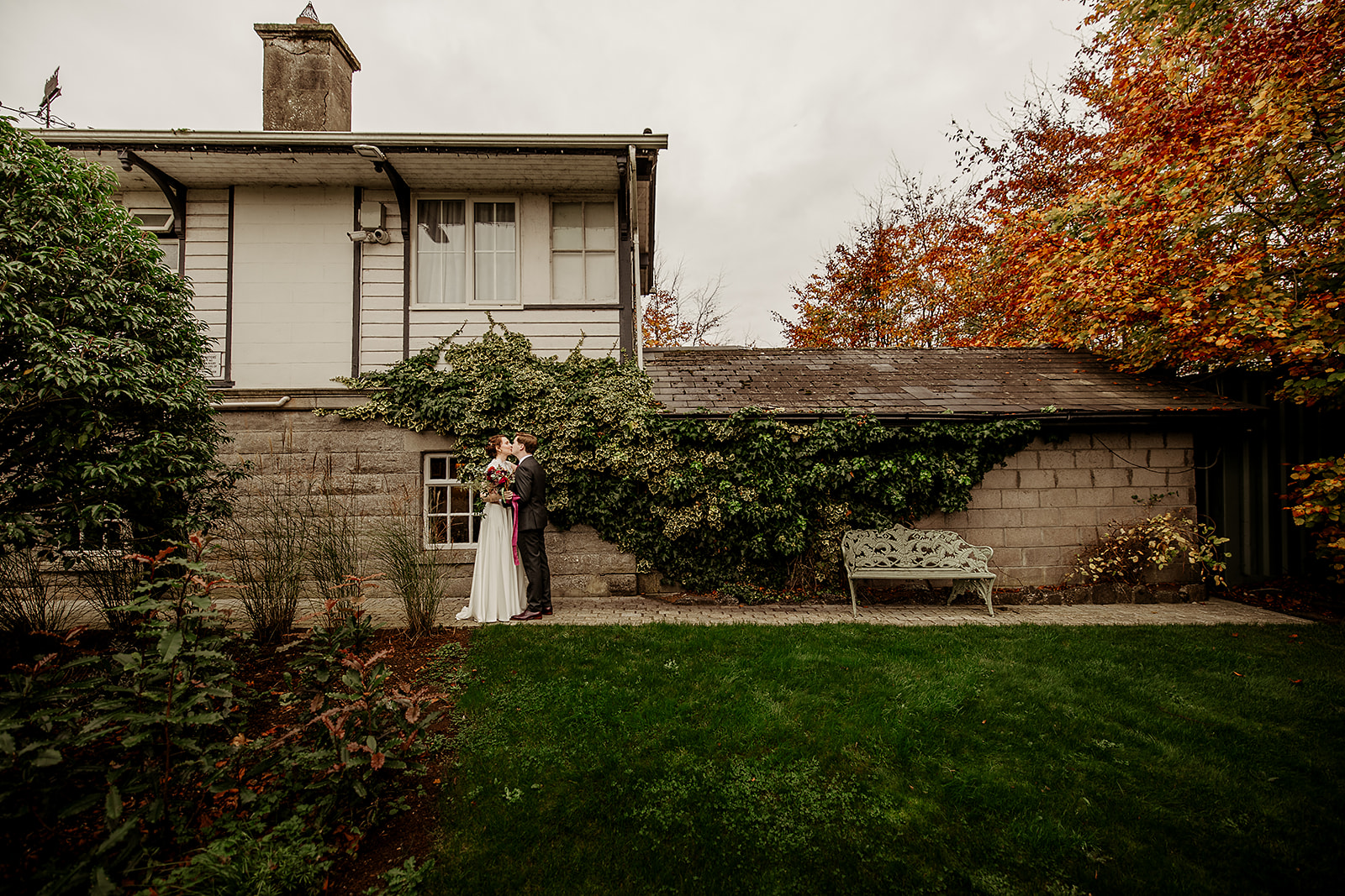 Sinead and Eoin beside the ivy and autumn trees at the Station House Hotel