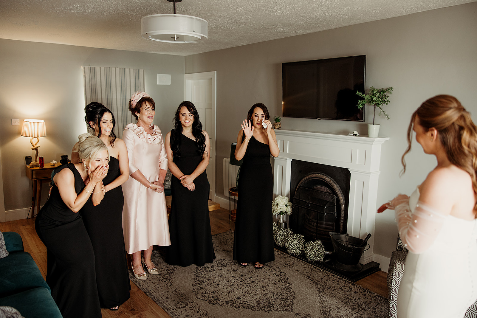 The room reacts as Alison appears in her wedding dress
