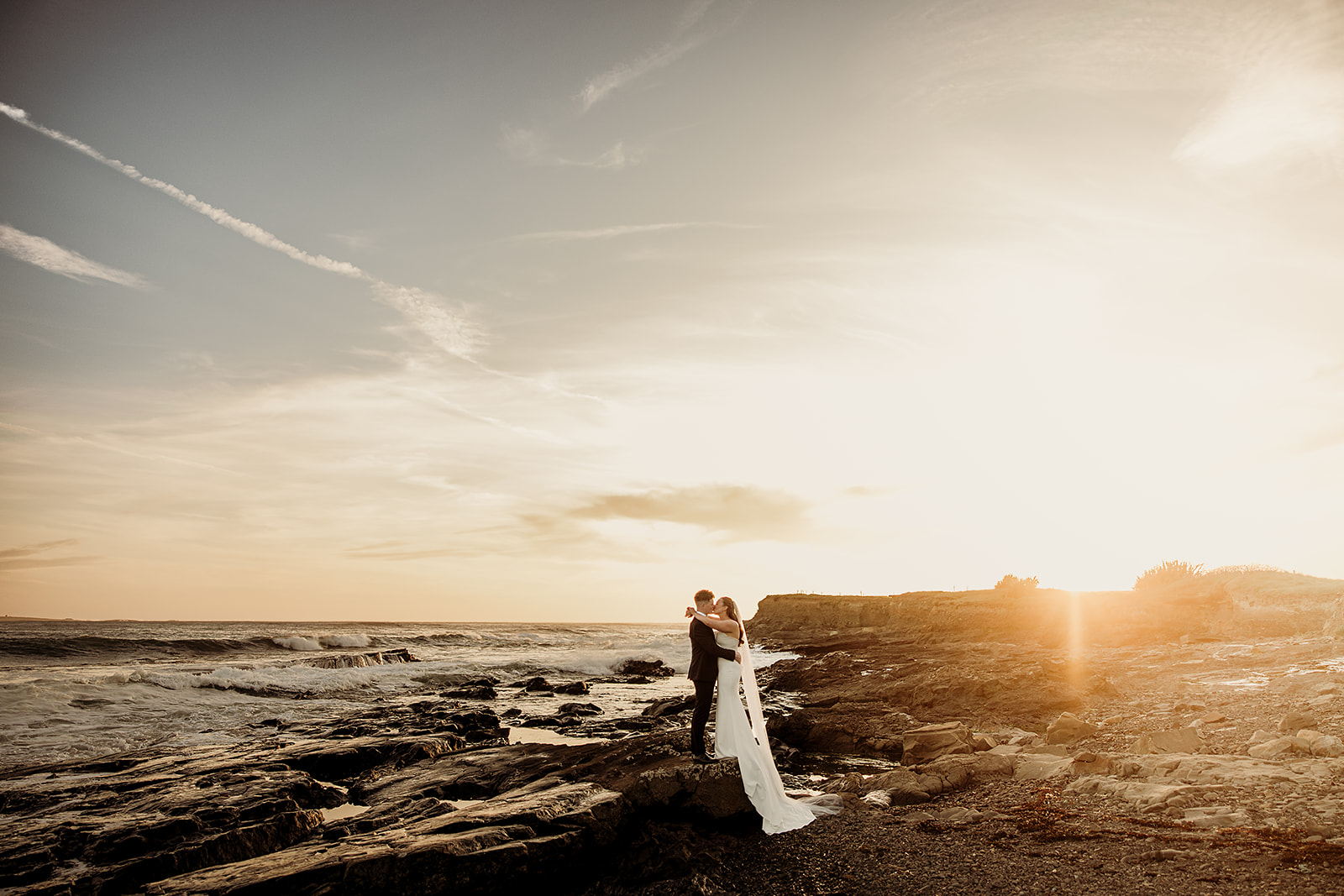 Alison and Ross together on the shore as the sun sets