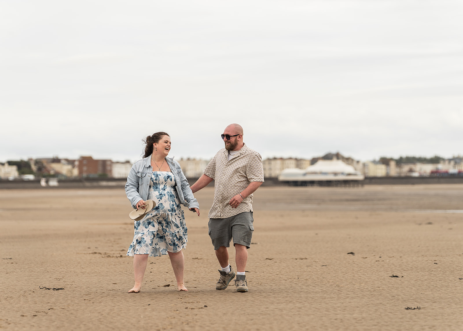 A couple walking together along the shoreline