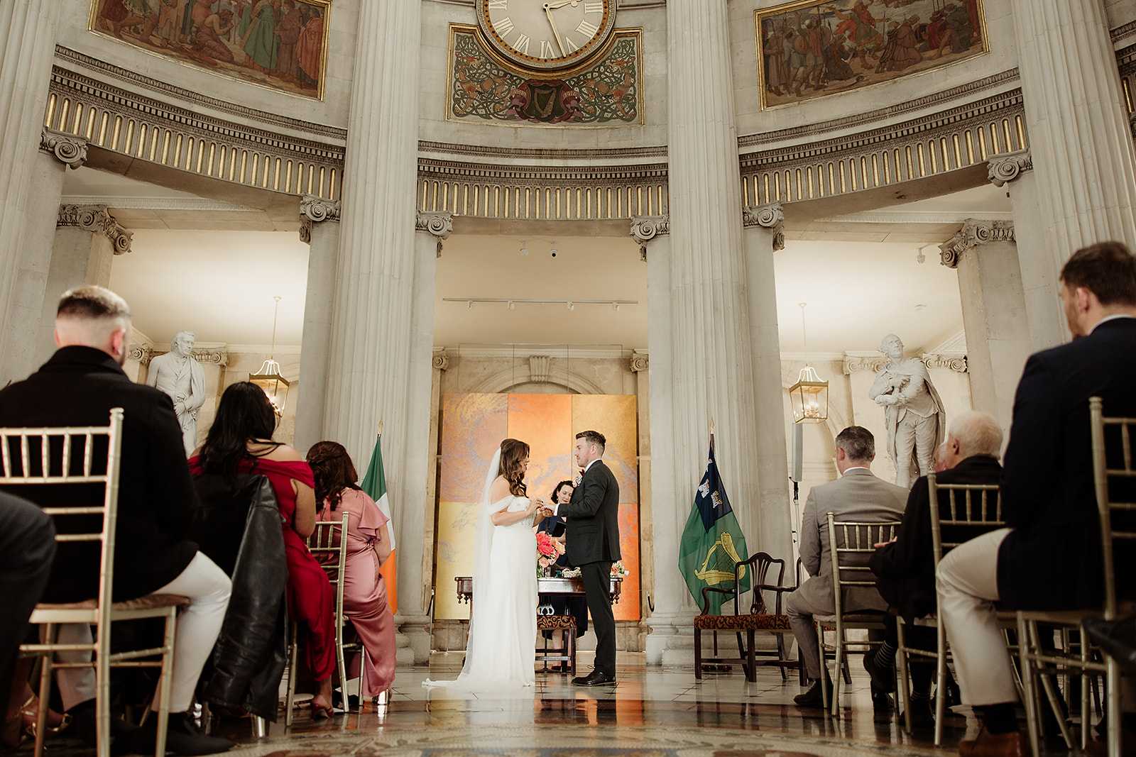 Claire and David exchanging rings beneath the columns of Dublin City Hall