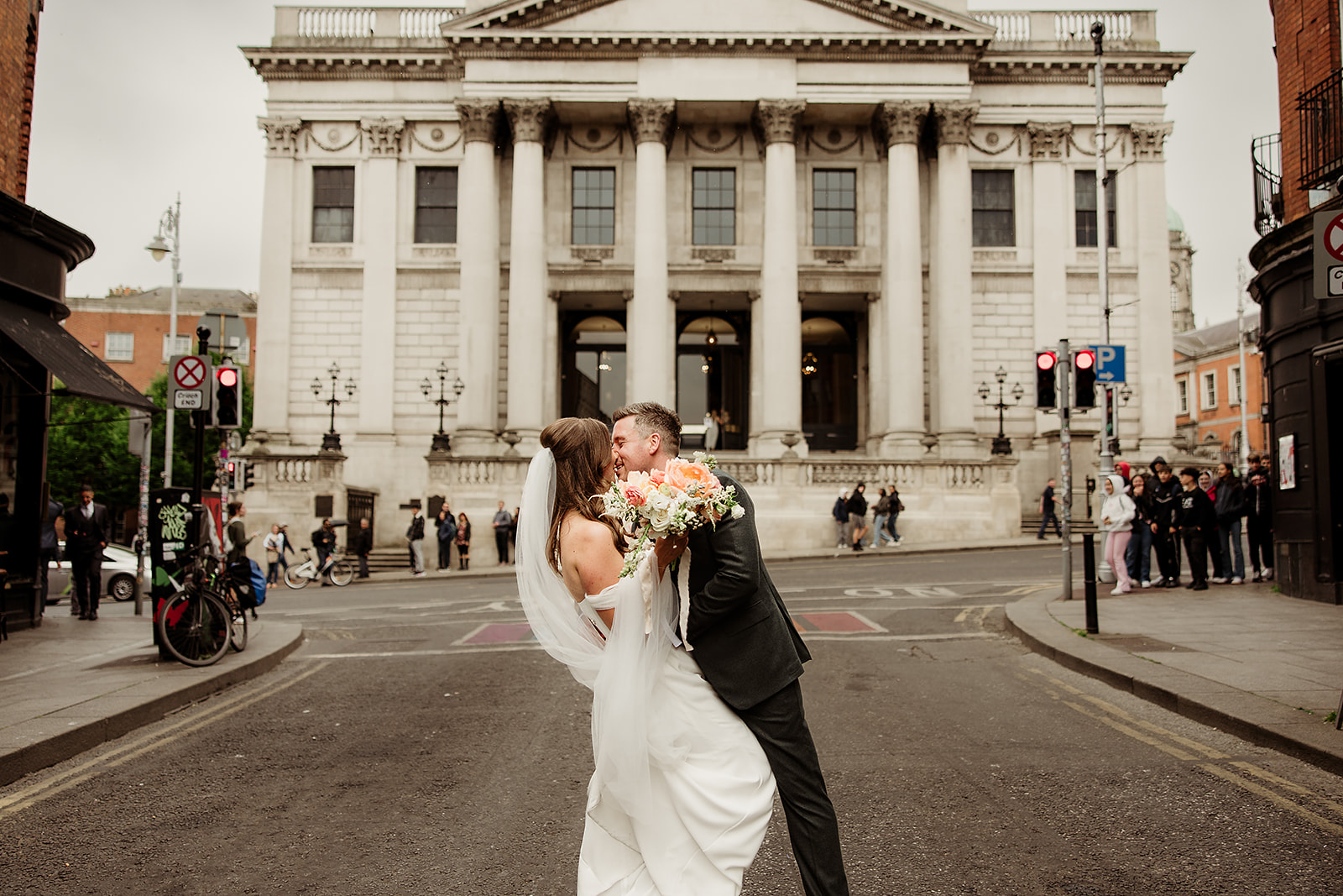 Claire and David kissing outside Dublin City Hall after their wedding ceremony