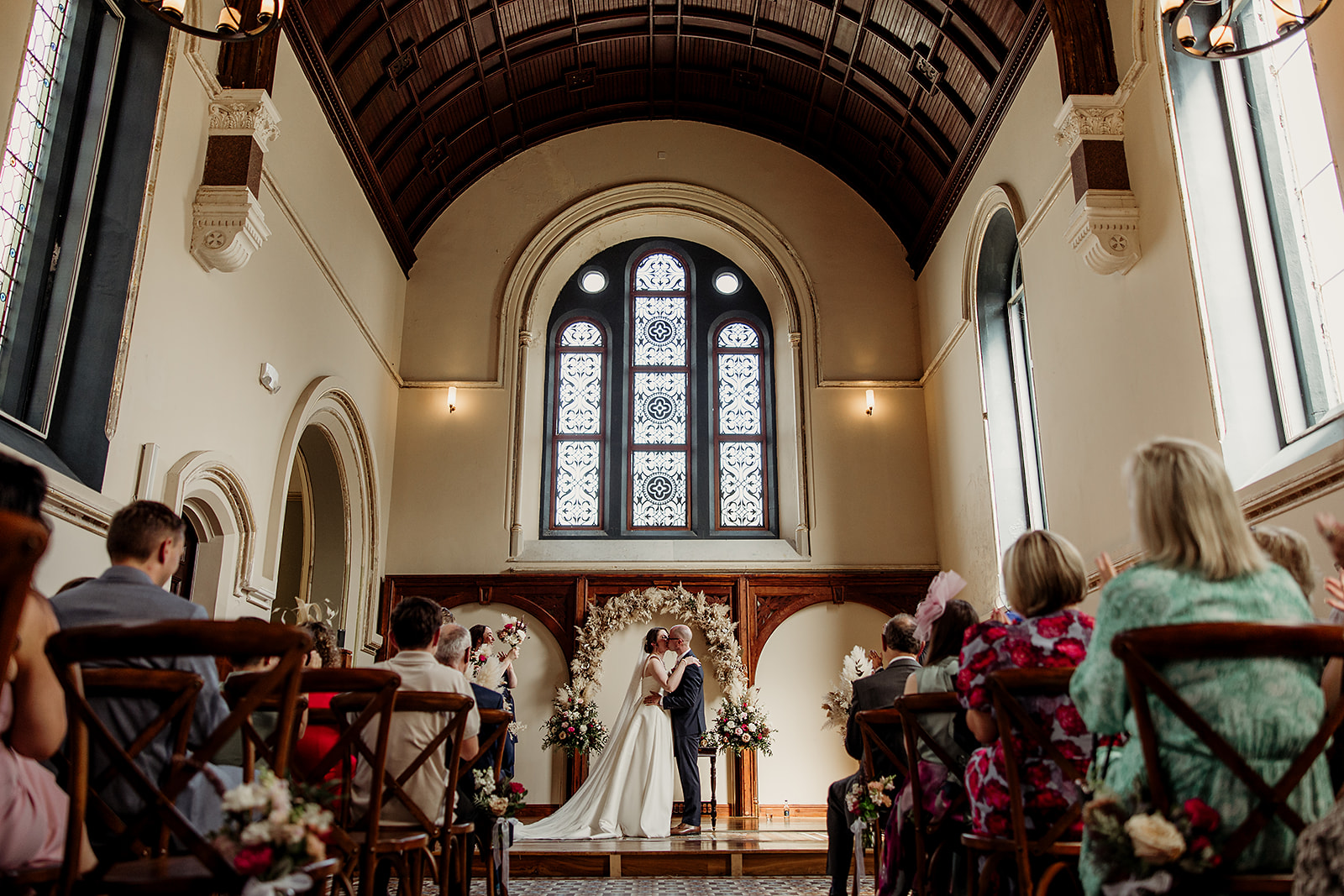 Valerie and Mark’s first kiss in The Abbey chapel, watched by their guests