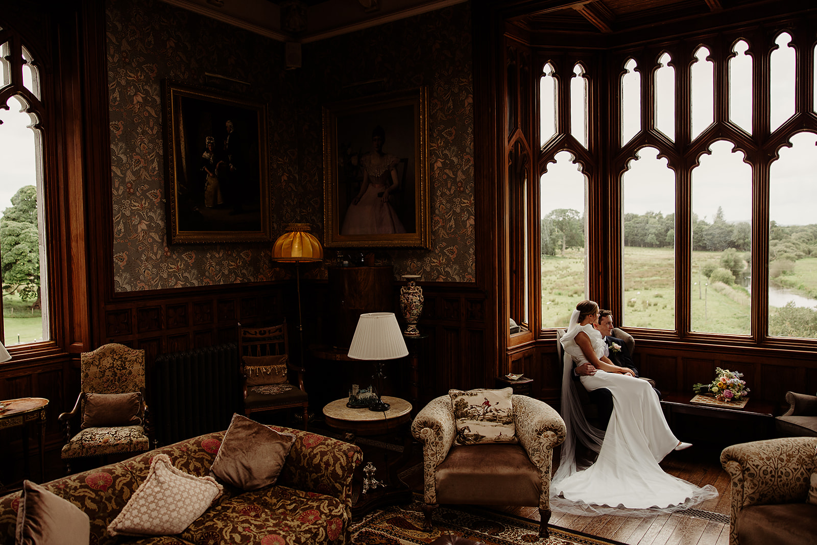 Gemma and David sitting by the tall windows at Markree Castle