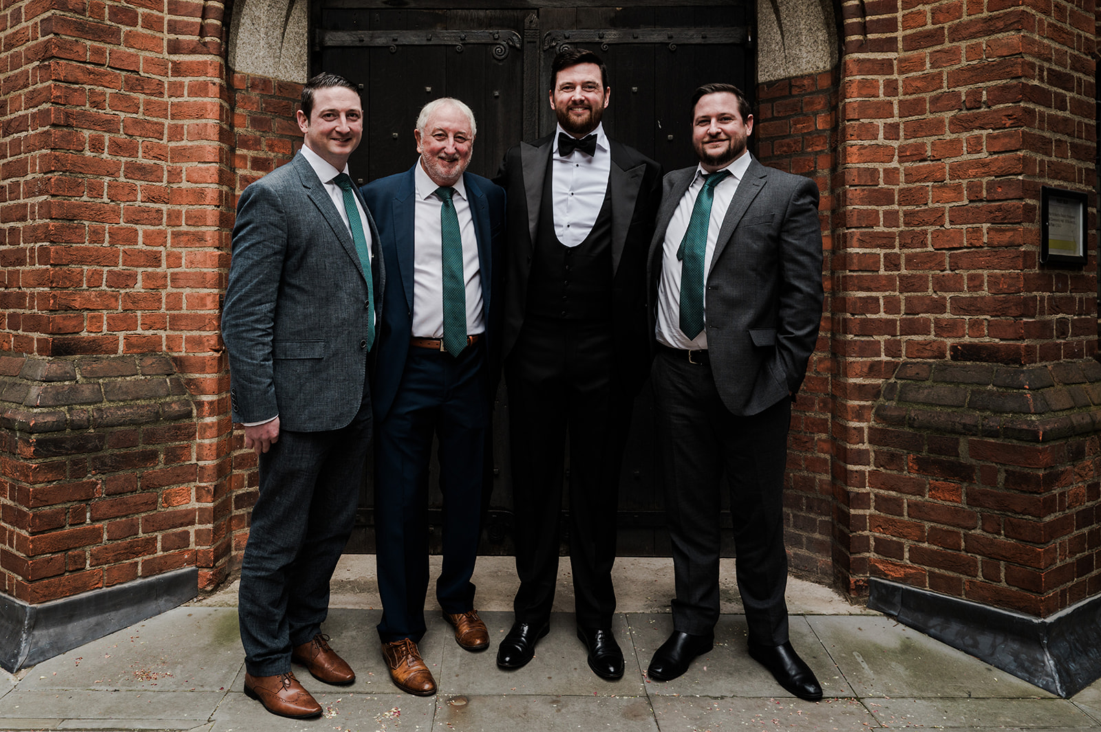 Couple portrait outside the church with bouquet