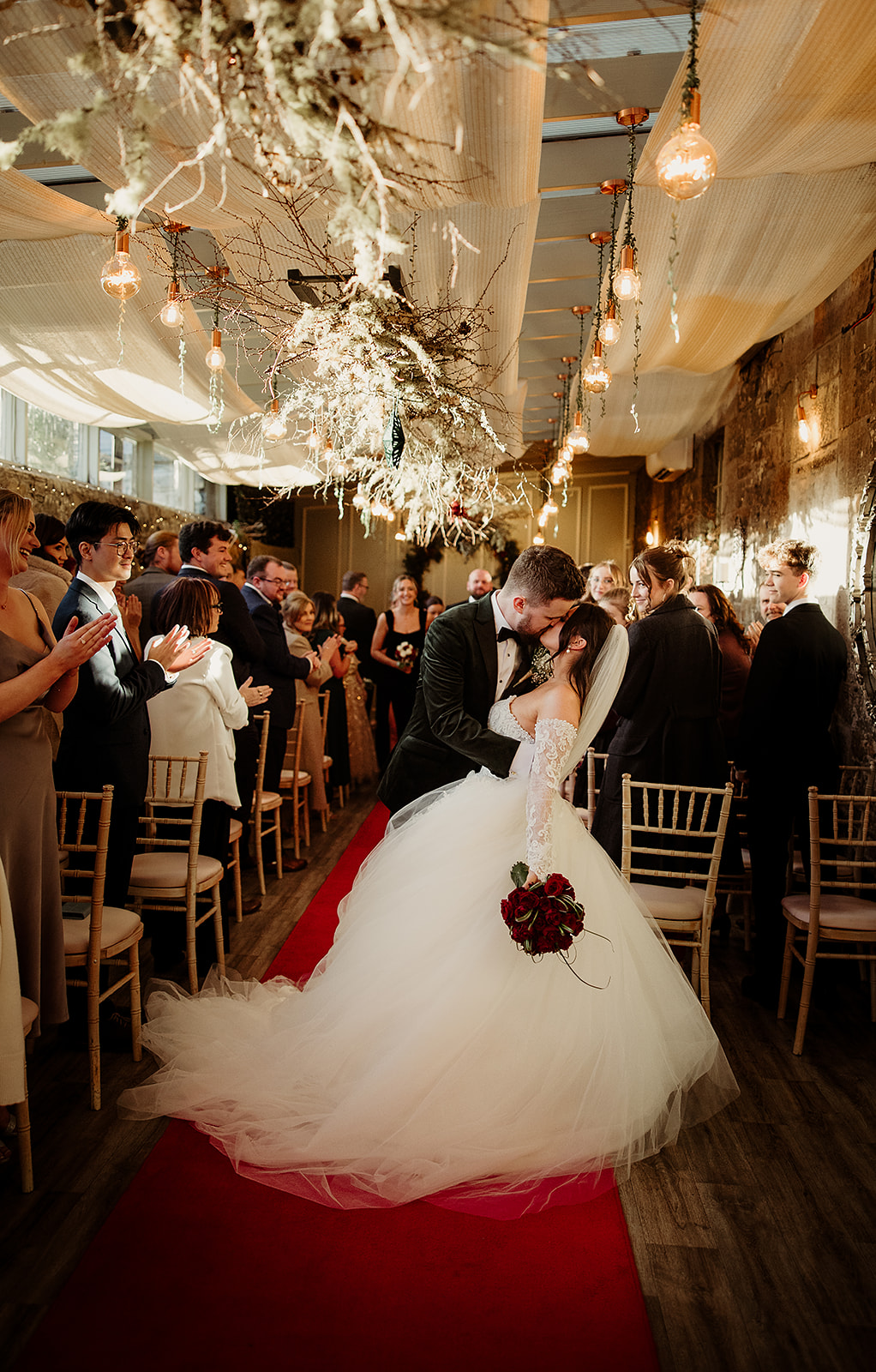 Jolene and Sean kissing as they walk back down the aisle