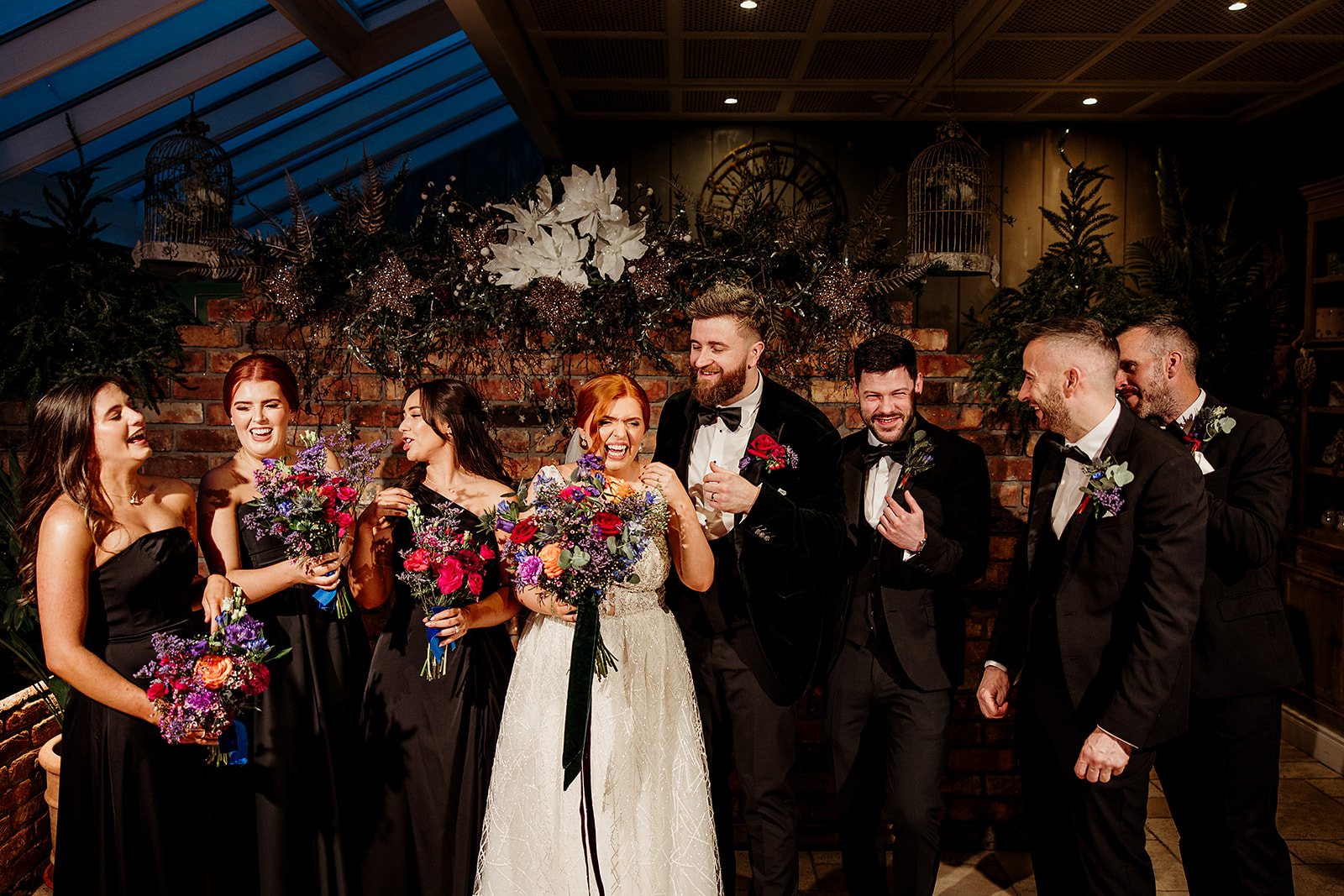 Caoimhe and James laughing with their wedding party at Ballymagarvey Village