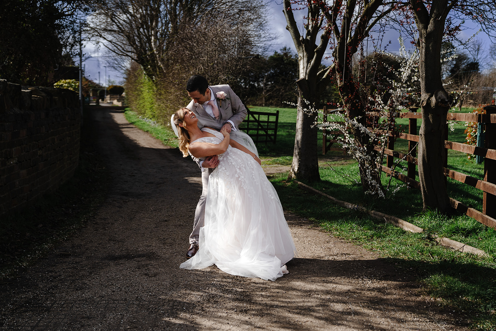 Hayley and Nick enjoying a couple portrait on the garden path at Northorpe Barn