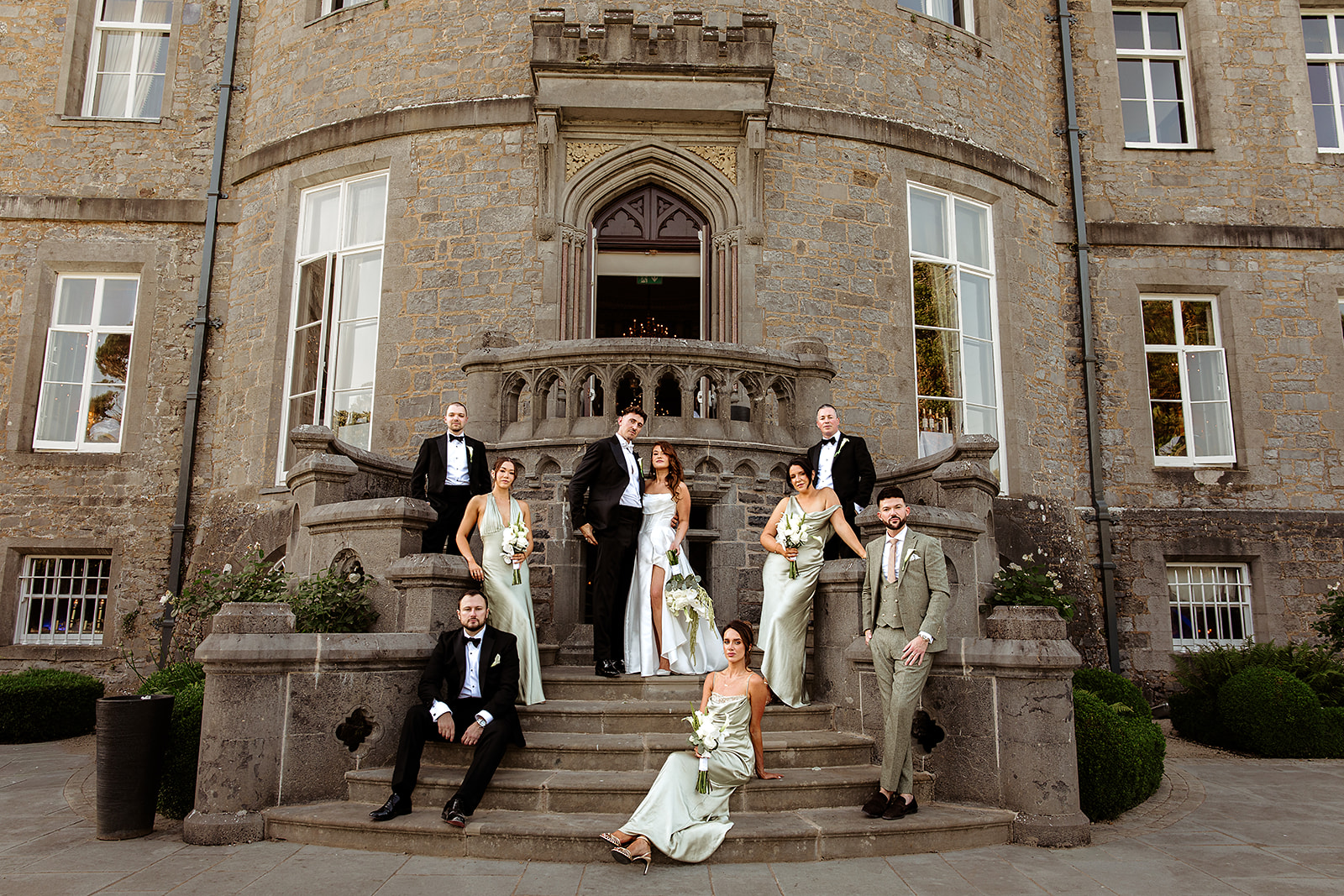 Olivia and Joseph with their wedding party on the steps of Markree Castle.