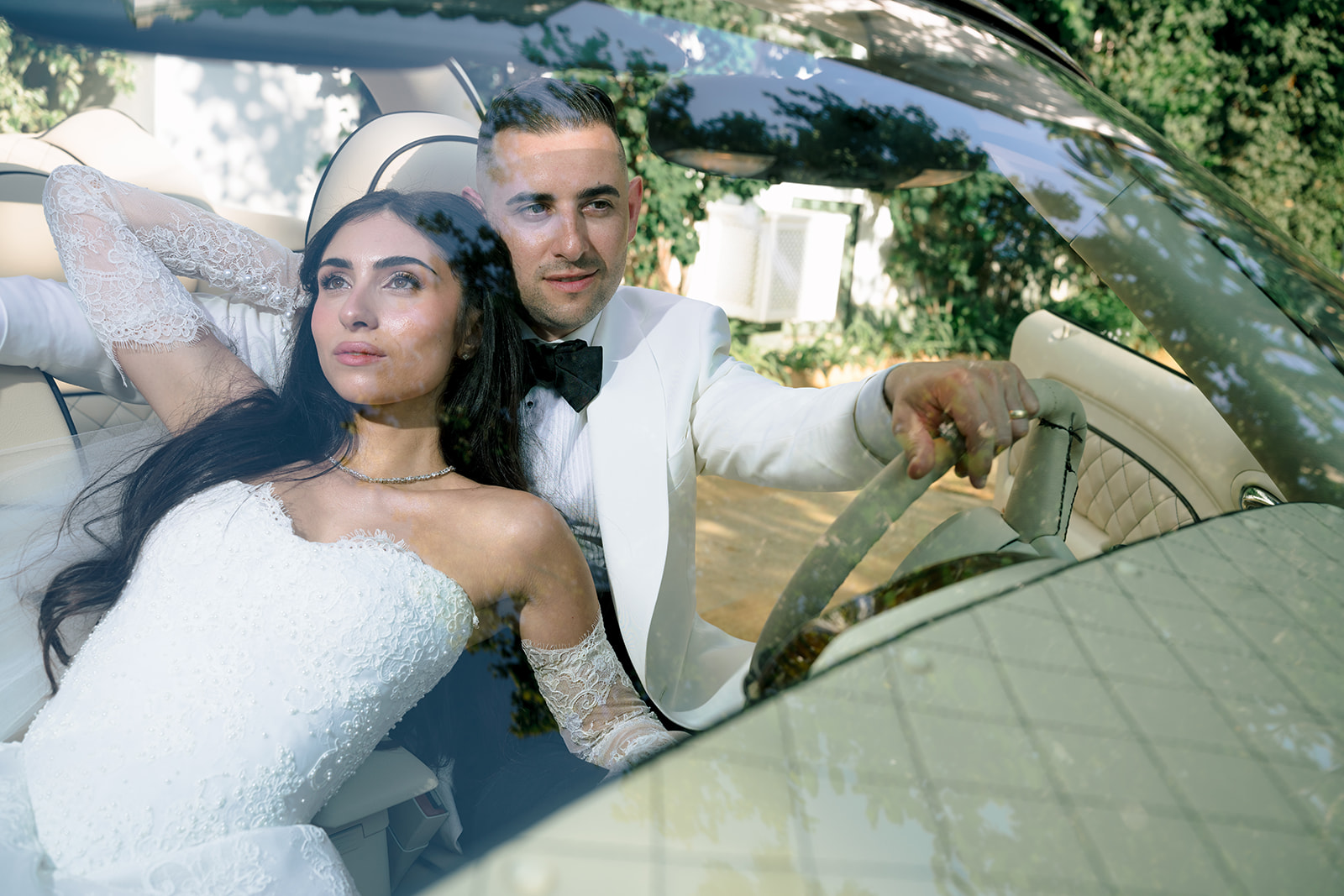 Bride and groom in a vintage convertible car in Seville