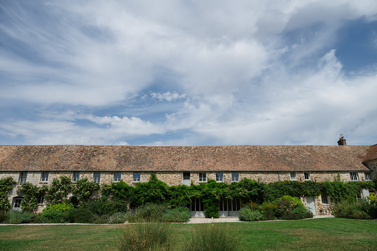 A French country estate with stone buildings and gardens outside Paris