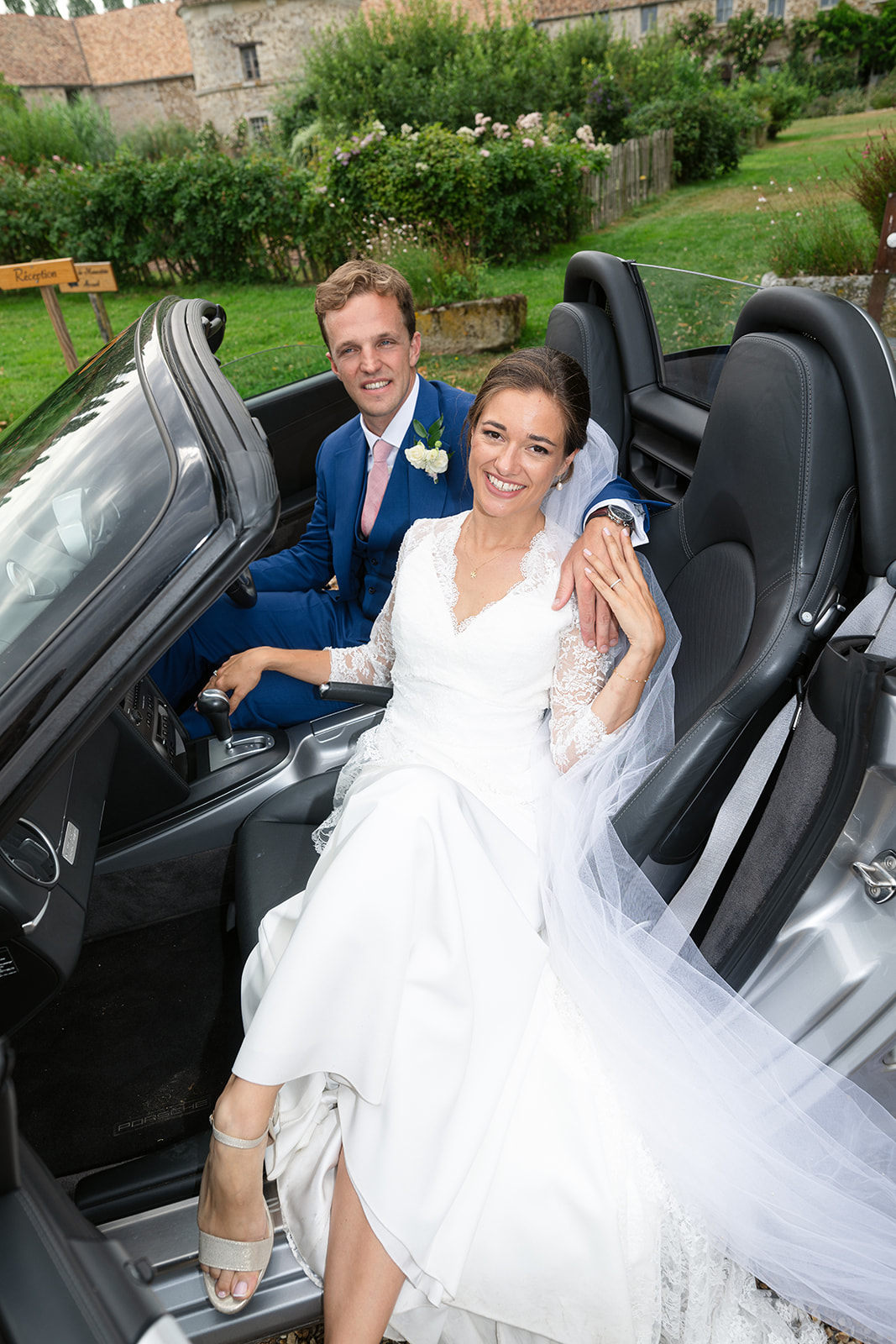 Paris wedding — bride and groom in a vintage convertible on a French country estate