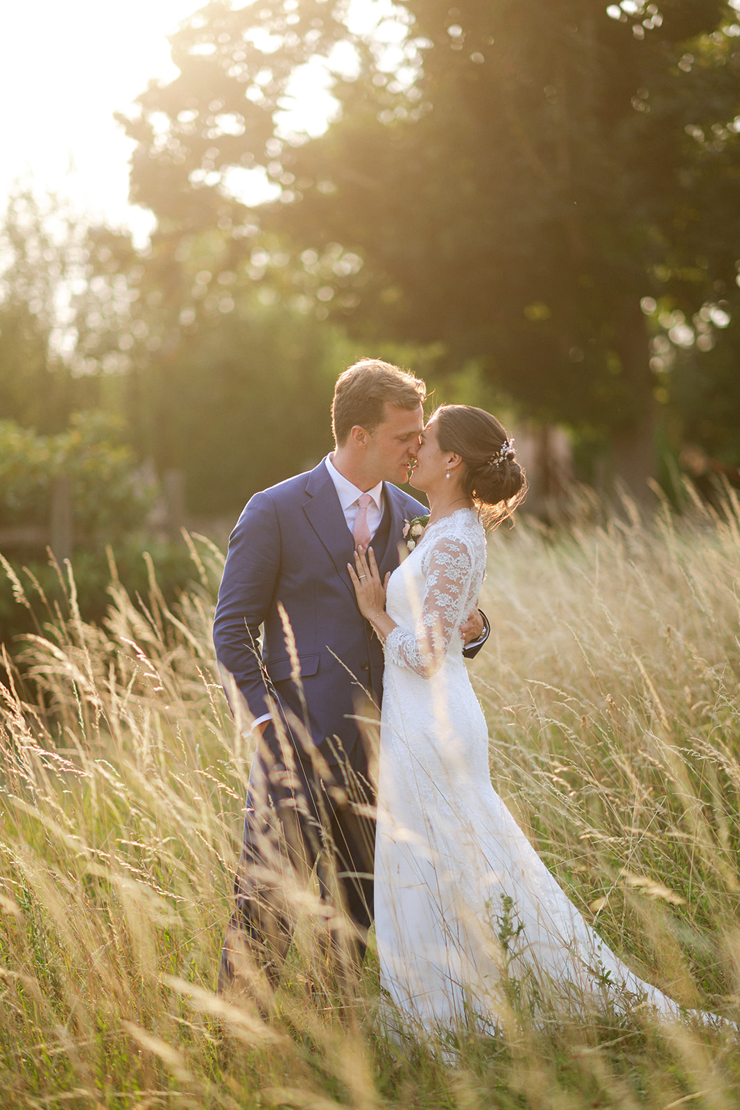 Bride and groom in a golden wheat field at sunset in France