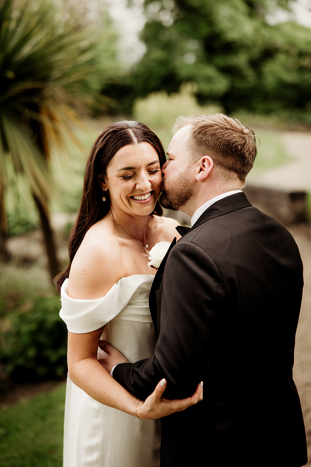 Jack kisses Ciara on the cheek in the gardens at Clonabreany House.