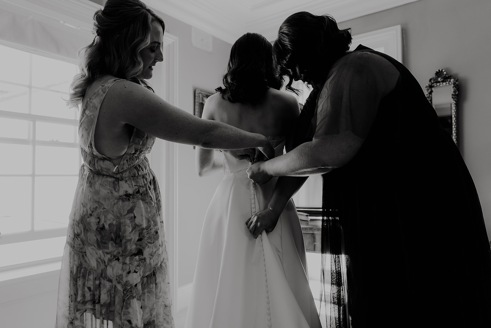 Helping Corrine into her wedding dress