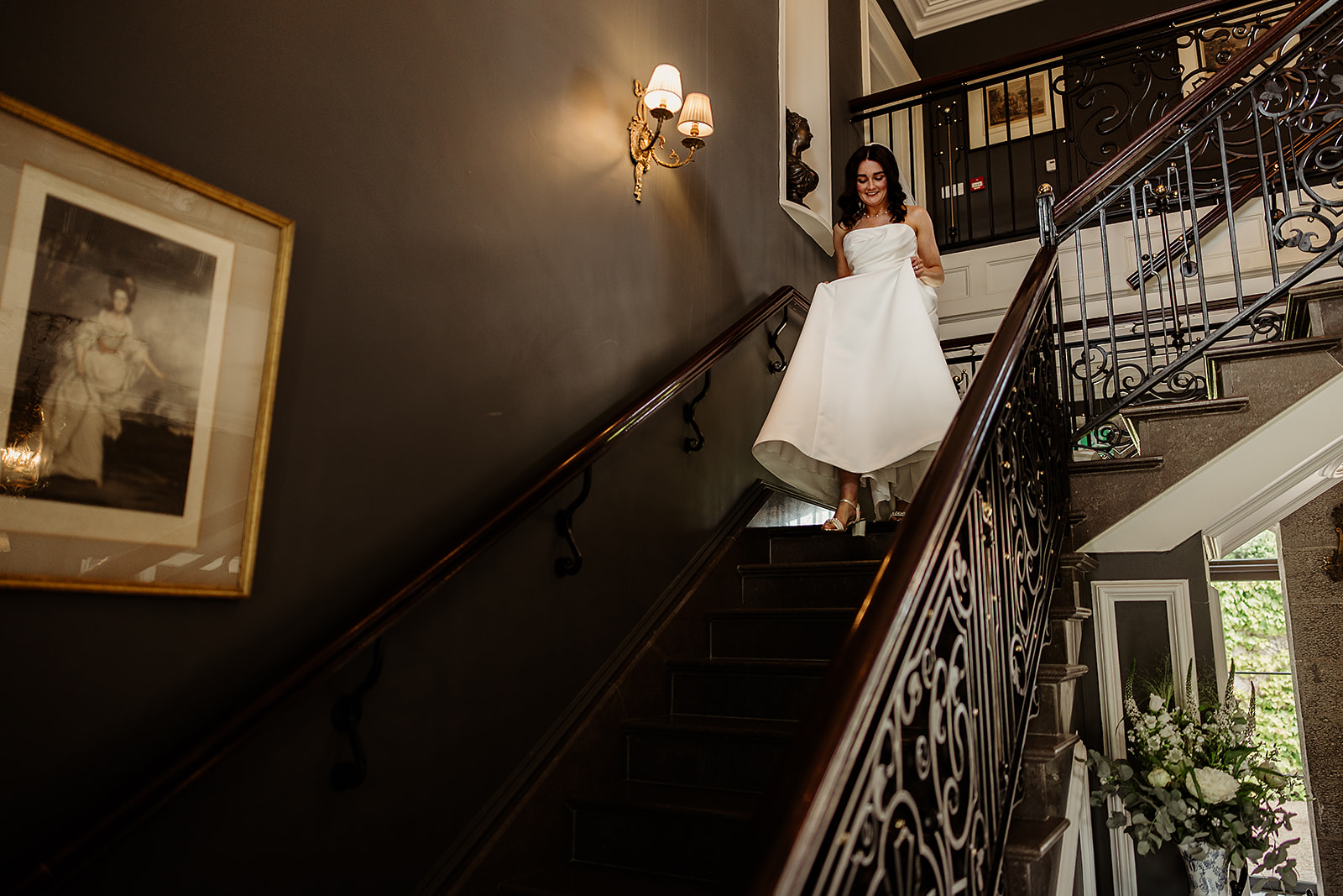 Corrine smiling as she walks down the staircase