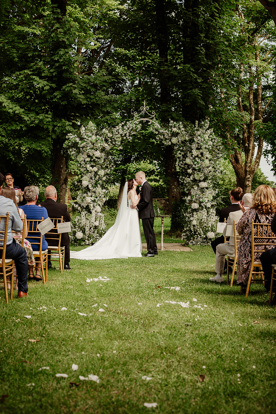 Corrine and David kiss during their woodland ceremony at Clonabreany House.