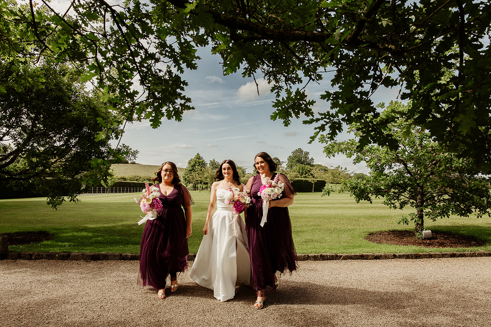 Corrine walking through the gardens with her bridesmaids